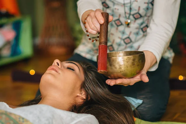 depositphotos_178799760-stock-photo-woman-using-tibetan-singing-bowl